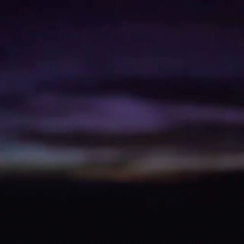 Close Up Of Man's Face In Darkness GIF