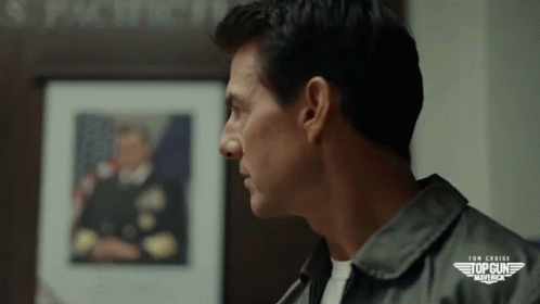 Close Up Of Man's Face In Front Of Top Gun Maverick GIF
