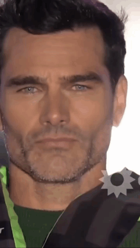 Close Up Of Man's Face With Badge GIF