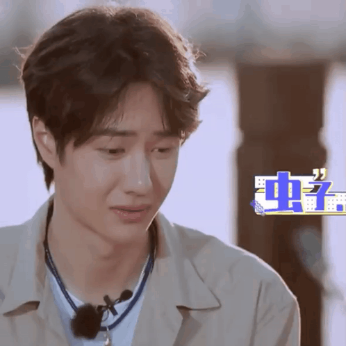 Close Up Of Man's Face With Chinese Writing GIF
