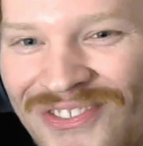 Close Up of Man's Face with Mustache and Teeth