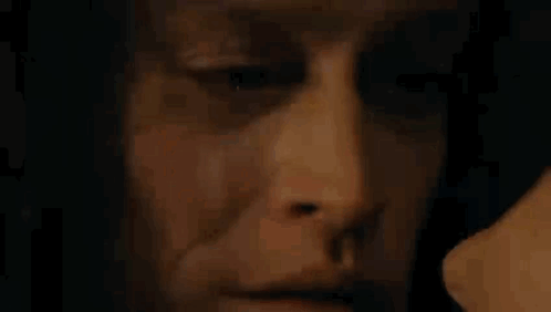 Close Up of Man's Face with Woman Behind