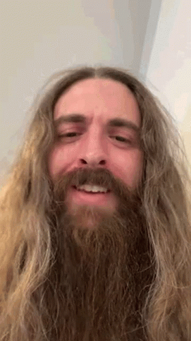 Close Up of Man With Long Hair and Beard Smiling