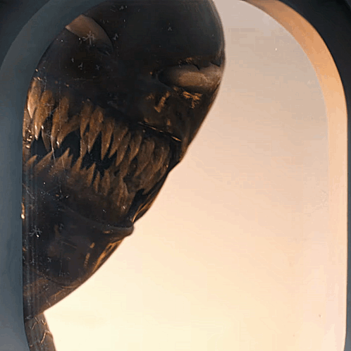 Close Up Of Monster Statue With Large Mouth GIF