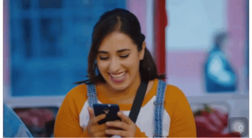 Close Up Of Person's Face With Blurred Flowers And Trees GIF