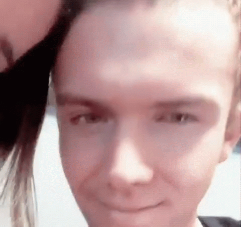 Close Up of Person's Face with Woman Behind