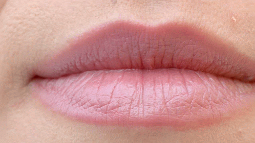 Close Up of Person's Teeth and Pink Lip