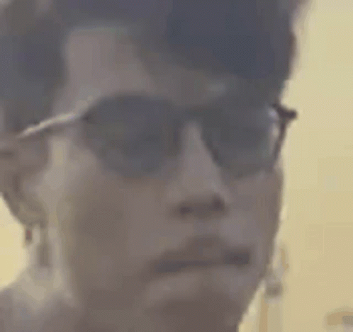 Close-Up of Person Wearing Sunglasses and Ear Buds