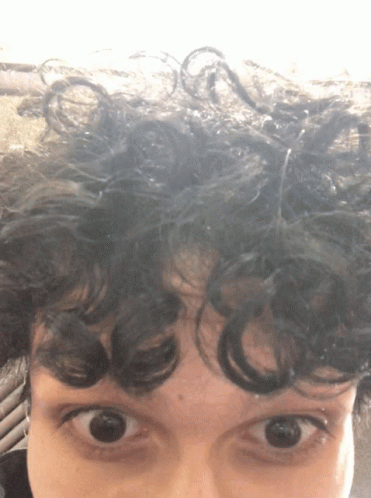 Close Up of Person With Curly Hair