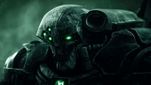 Close Up of Robot With Green Eyes and Letter T on Chest