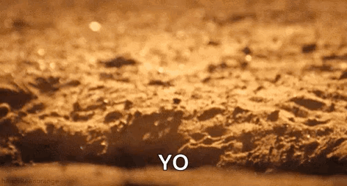 Close Up of Sandy Surface Saying Yo