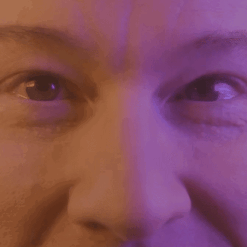 Close Up of Woman Eyes and Nose Purple Background
