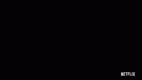 Close Up of Woman's Face in Dark Room with Netflix Logo