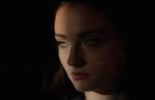Close Up Of Woman's Face In The Dark GIF