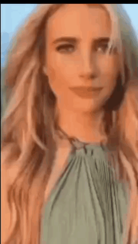 Close Up of Woman's Face with Blonde Hair and Green Top