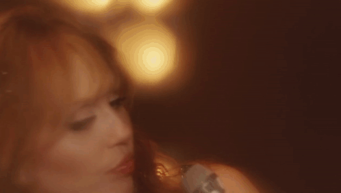 Close Up of Woman's Face With Blurry Lights Background