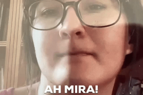 Close Up of Woman's Face With Glasses and Words Ah Mira