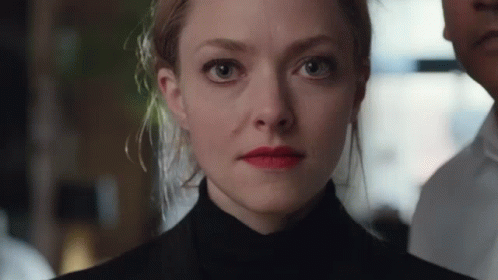 Close Up of Woman's Face With Man in Background