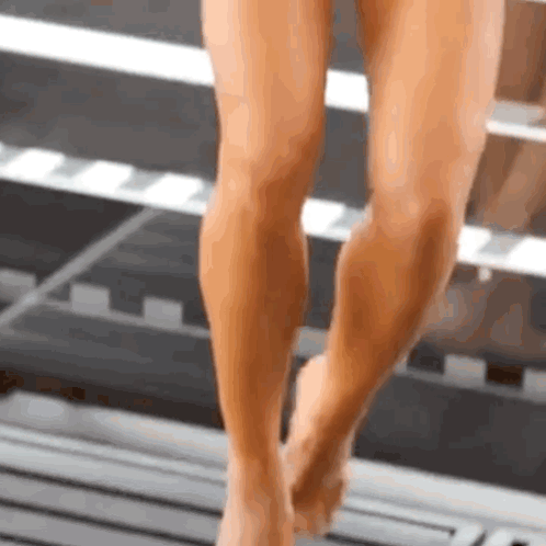 Close Up of Woman's Legs and Feet Walking on Wooden Floor