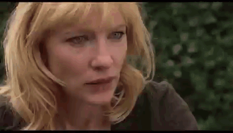 Close Up of Woman With Blonde Hair and Blue Eyes Looking at Camera