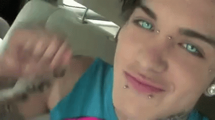 Close Up of Woman With Face Piercings and Arm Tattoo