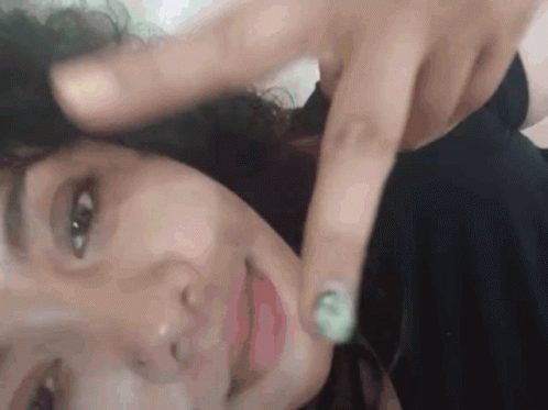 Close Up Of Woman With Finger On Face GIF