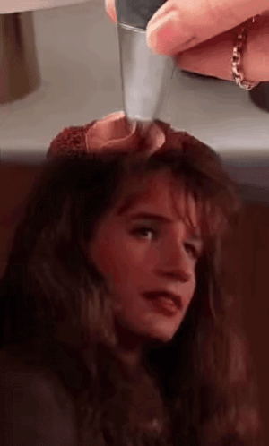 Close Up of Woman With Knife in Head