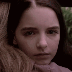 Close Up Of Young Girl With Woman Arm Around Neck GIF