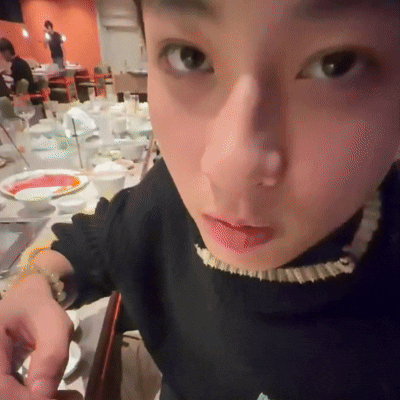 Close-Up Person Face in Front of Table Full of Food