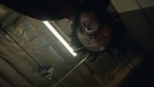 Close Up Person's Head Hanging From Ceiling GIF