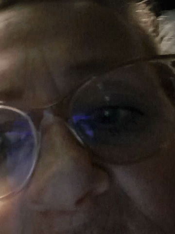 Close Up Person With Glasses And Blue Light GIF