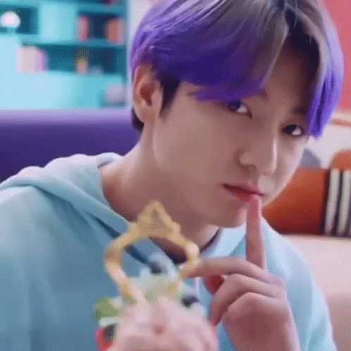 Close Up Person with Purple Hair Holding Trophy