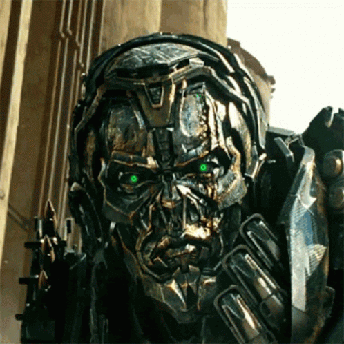 Close Up Robot With Green Eyes in Front of Building