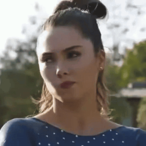 Close Up Woman Face with Bun and Earrings