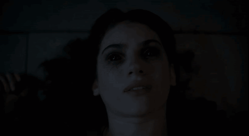 Close-Up Woman Face With Dark Background GIF