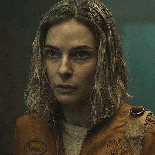 Close Up Woman in Brown Jacket With Badge