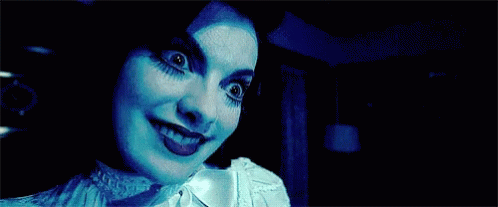 Close Up Woman's Face In Dark GIF
