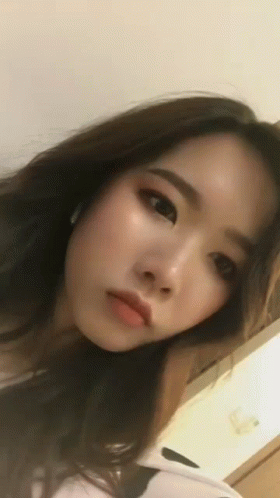 Close Up Woman's Face Looking At Camera GIF