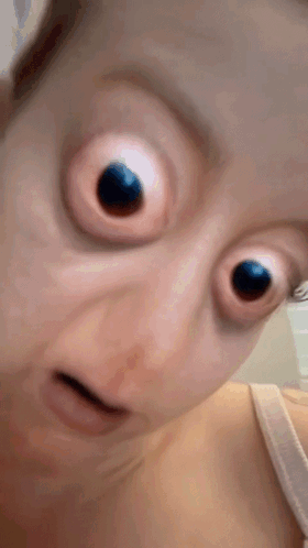 Close Up Woman's Face With Big Eyes GIF