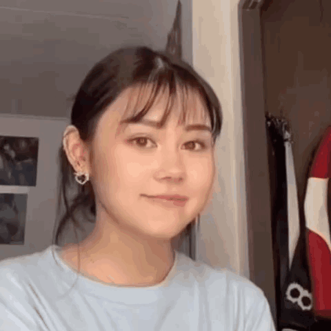 Close Up Woman's Face With Ponytail And Earrings GIF