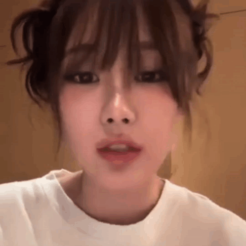 Close Up Woman's Face with White Shirt and Bun