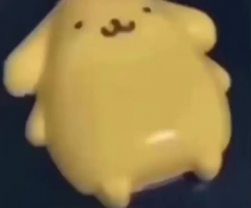 Close Up Yellow Stuffed Animal Floating on Blue Surface