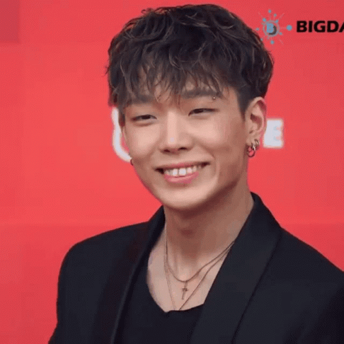 Close Up Young Man Smiling in Black Jacket and Necklace