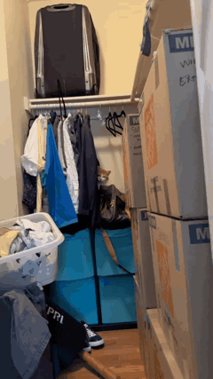 Closet With Boxes and Suitcase Saying MI