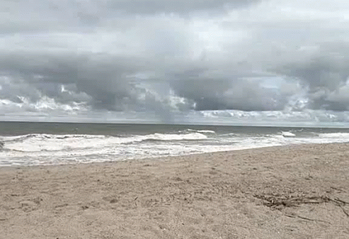 Cloudy Beach With Crashing Waves GIF
