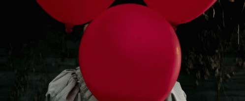 Clown Holding Red Balloon