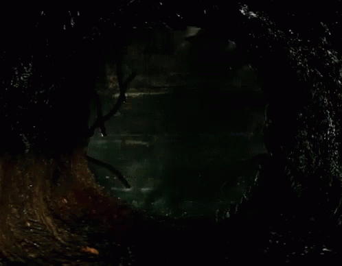 Clown in Dark Room with Brick Wall