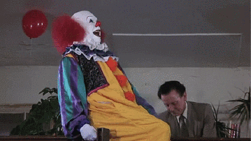 Clown Next to Man in Suit and Tie