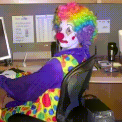 Clown Sitting at Desk with Computer