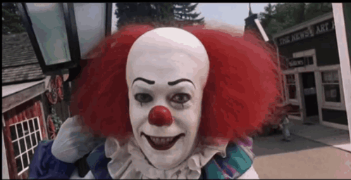 Clown Smiling In Front Of Building That Says The News GIF